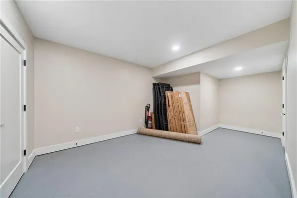 an empty room with staircase and white walls