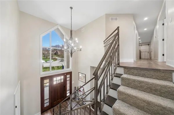 a view of entryway and hall with wooden floor