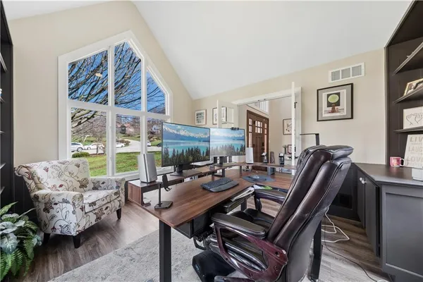 a living room with furniture a flat screen tv and a floor to ceiling window