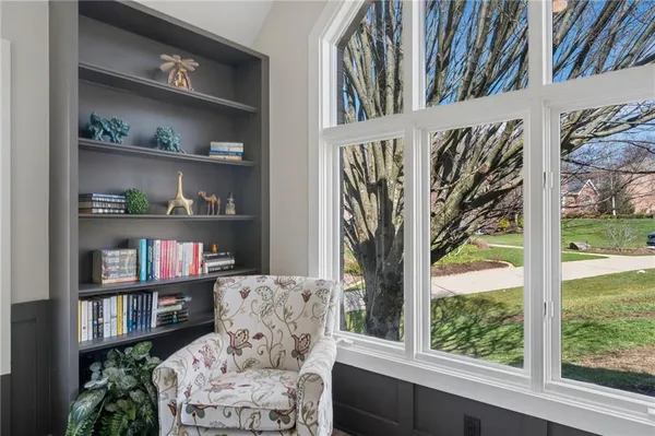 a living room with furniture and a book shelf