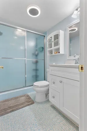 a bathroom with a toilet a sink and shower