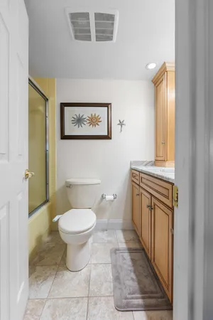 a bathroom with a toilet a sink and a window