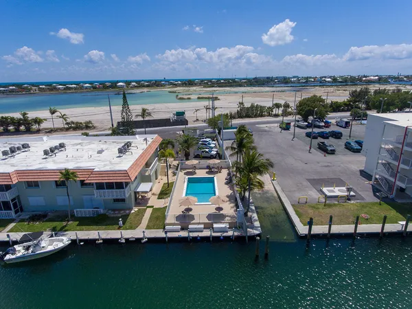 an aerial view of a house with a garden and lake view