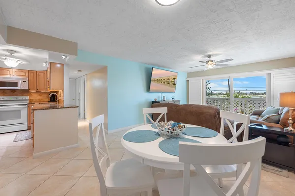 a view of a dining room with furniture a livingroom and chandelier