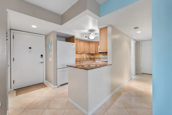 a kitchen with kitchen island a counter top space cabinets and stainless steel appliances