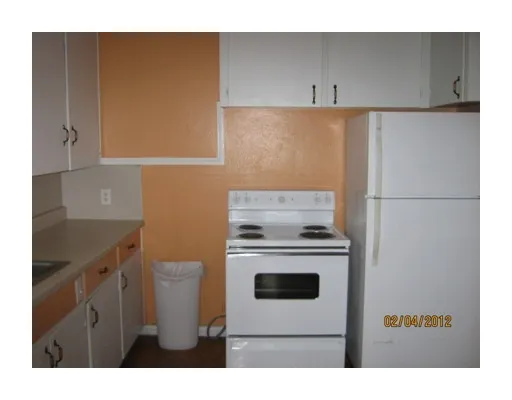 a kitchen with a stove and a refrigerator