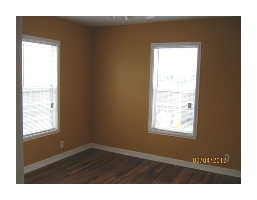 3461 Lawnview Street Corpus Christi, TX 78411 - Photo 6 of 10 a view of an empty room with wooden floor and a window