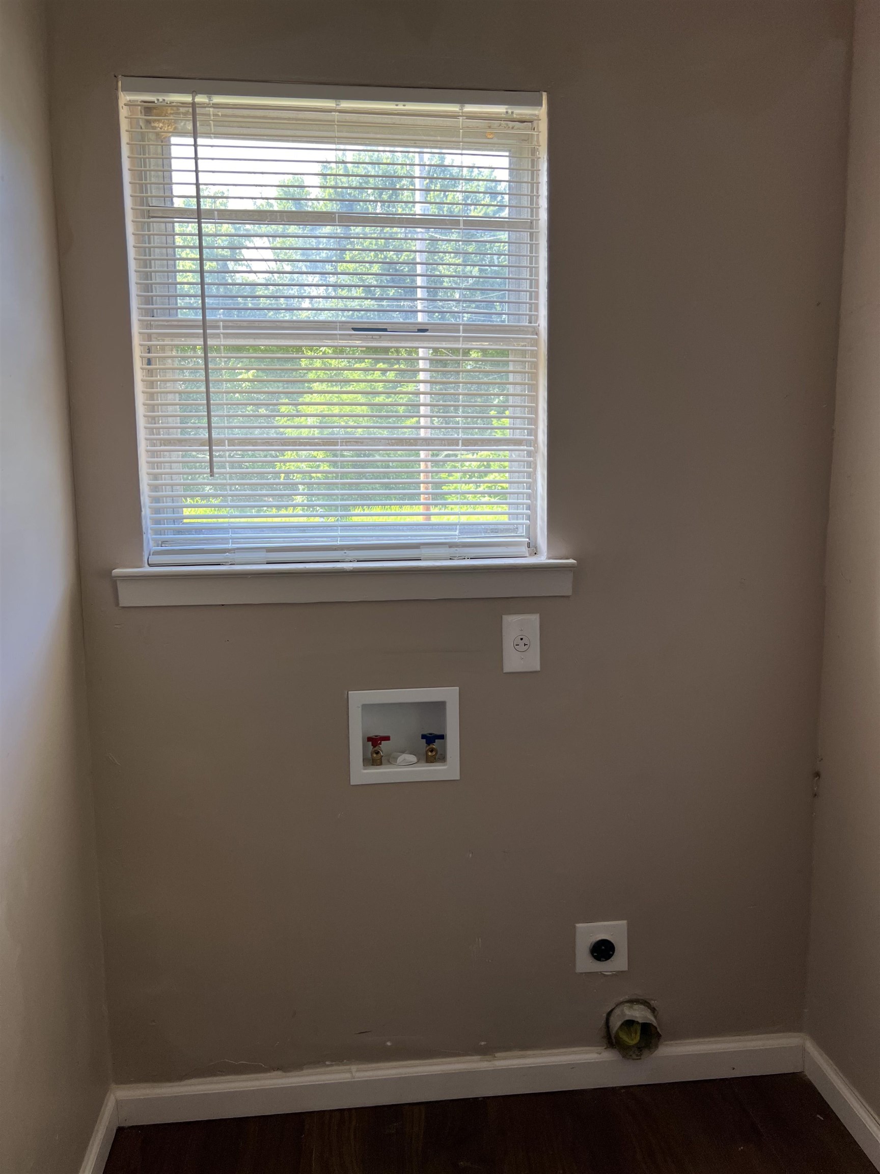 794 Nonconnah Road Memphis, TN 38109 - Photo 6 of 6 Window with blinds, wall-mounted laundry hookups, and wood-finish flooring
