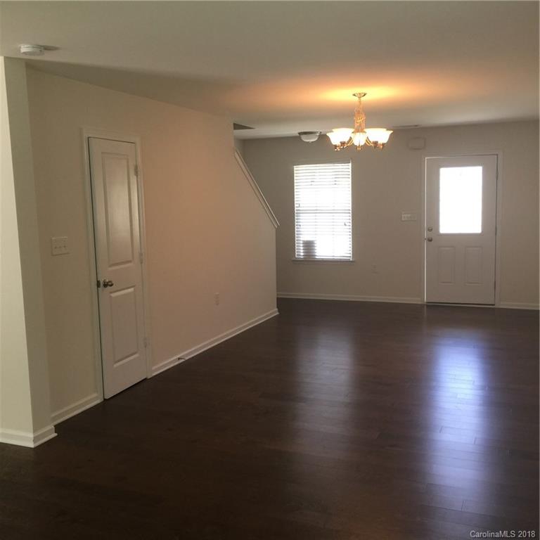 3018 Arthur Road, Unit 165 Indian Land, SC 29707 - Photo 3 of 19 an empty room with wooden floor and windows