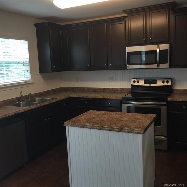 3018 Arthur Road, Unit 165 Indian Land, SC 29707 - Photo 5 of 19 a kitchen with granite countertop stainless steel appliances and cabinets