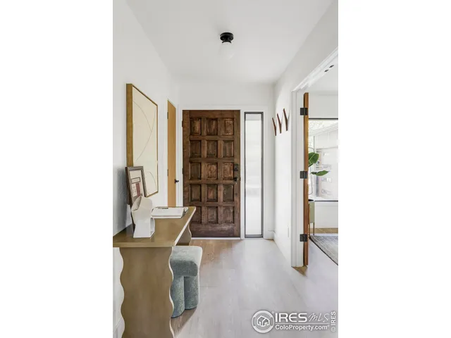 a view of a hallway with furniture and entryway
