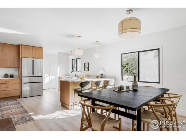 a kitchen with a table chairs and refrigerator