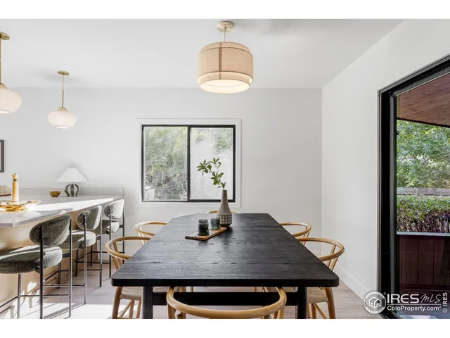 a view of a dining room with a table and chairs
