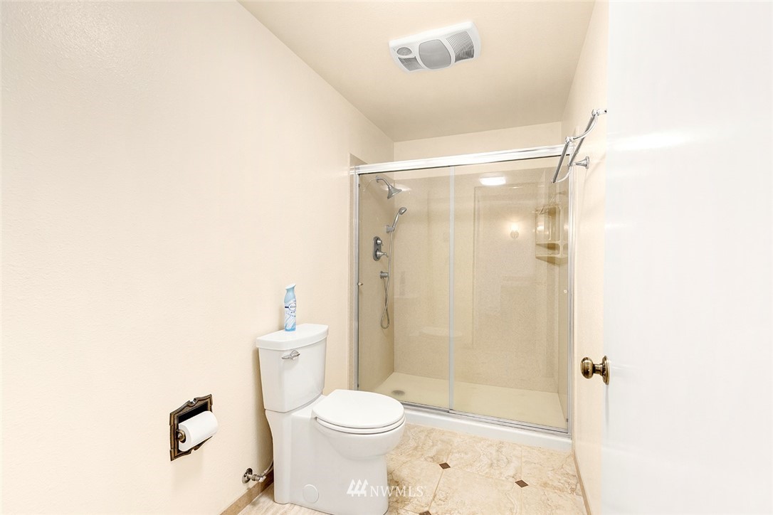 1381 Wynoochee Valley Road Montesano, WA 98563 - Photo 13 of 40 a bathroom with a shower a toilet and a window