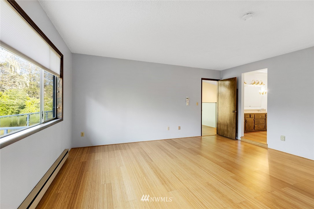 1381 Wynoochee Valley Road Montesano, WA 98563 - Photo 15 of 40 a view of an empty room with glass door and wooden floor