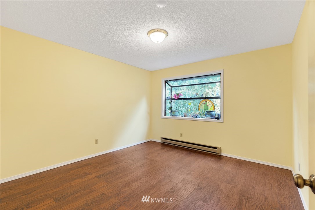 1381 Wynoochee Valley Road Montesano, WA 98563 - Photo 17 of 40 an empty room with wooden floor and windows