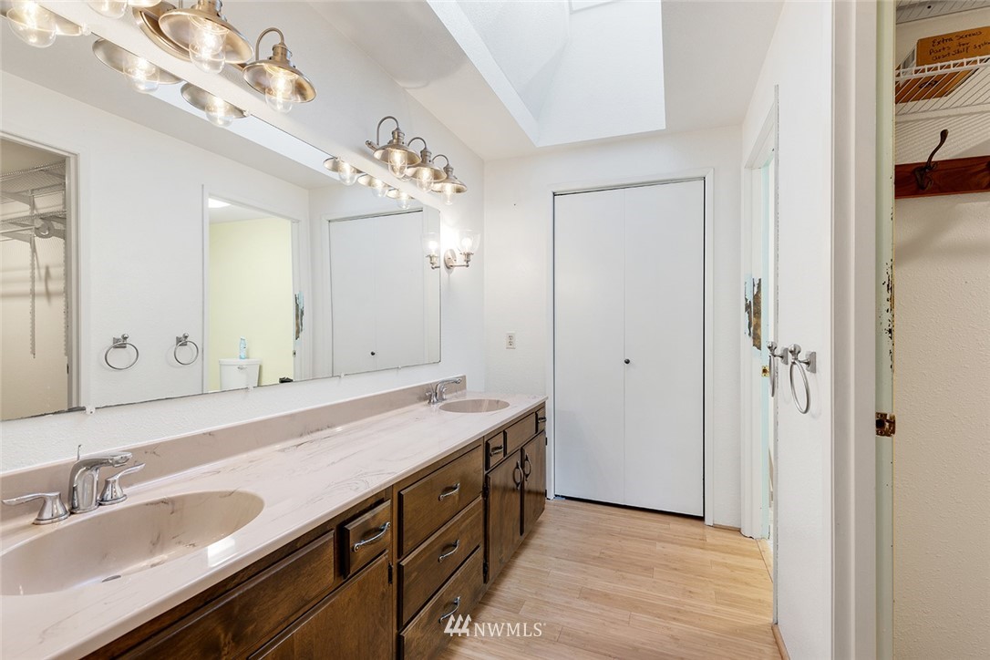 1381 Wynoochee Valley Road Montesano, WA 98563 - Photo 20 of 40 a spacious bathroom with a granite countertop sink a mirror and a shower
