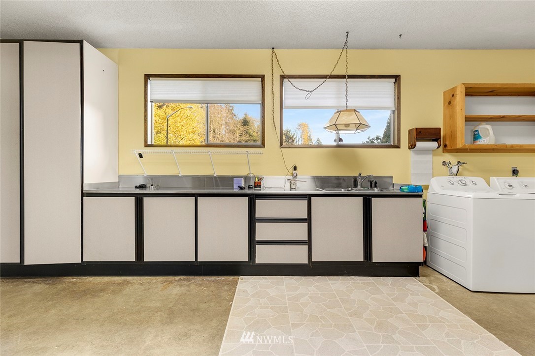 1381 Wynoochee Valley Road Montesano, WA 98563 - Photo 22 of 40 a bathroom with a granite countertop sink and a large mirror next to a window