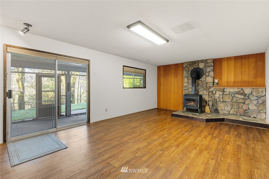 1381 Wynoochee Valley Road Montesano, WA 98563 - Photo 24 of 40 a view of empty room with floor to ceiling window and wooden floor