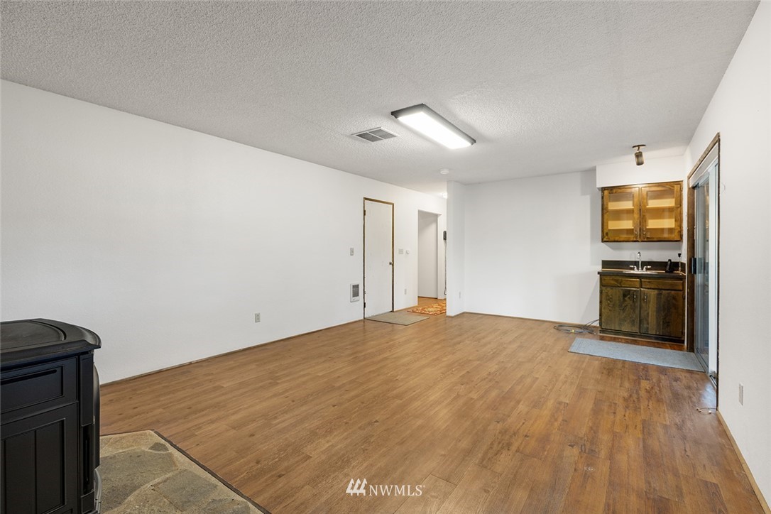 1381 Wynoochee Valley Road Montesano, WA 98563 - Photo 25 of 40 a view of a kitchen with a dishwasher cabinets and a wooden floor