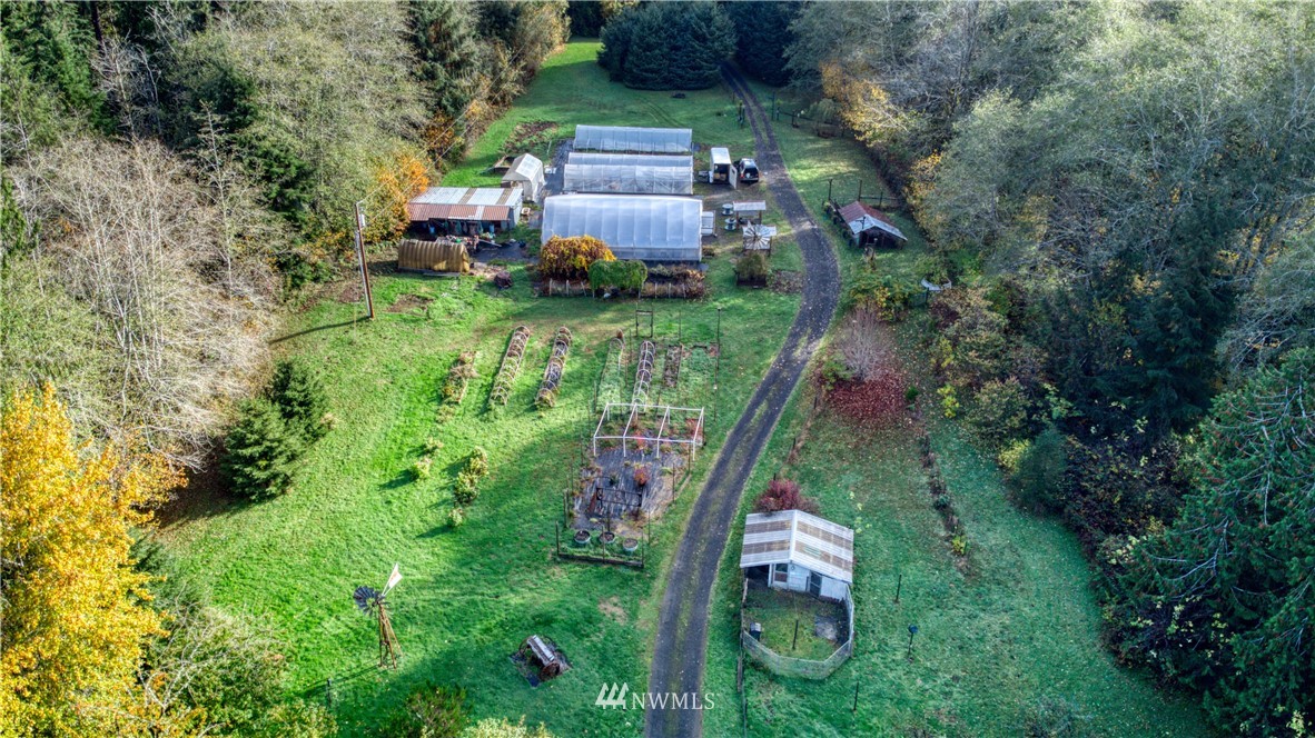 1381 Wynoochee Valley Road Montesano, WA 98563 - Photo 27 of 40 a backyard of a house with outdoor seating and plants