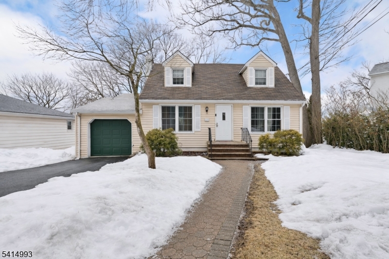 627 East Vail Road Landing, NJ 07850 - Photo 1 of 26 a front view of a house with a yard and garage