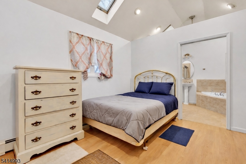 627 East Vail Road Landing, NJ 07850 - Photo 12 of 26 a bedroom with a bed and a painting on the wall