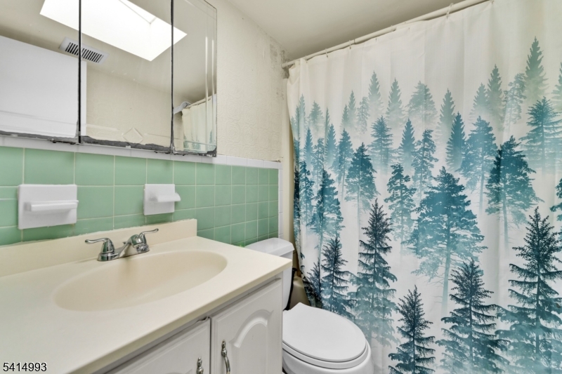 627 East Vail Road Landing, NJ 07850 - Photo 20 of 26 a bathroom with a sink toilet and shower