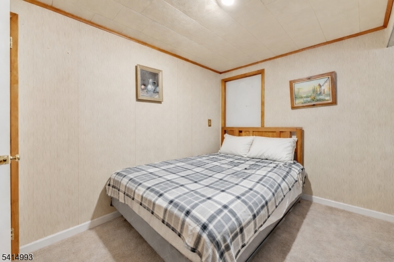 627 East Vail Road Landing, NJ 07850 - Photo 22 of 26 a bedroom with a bed and painting on the wall