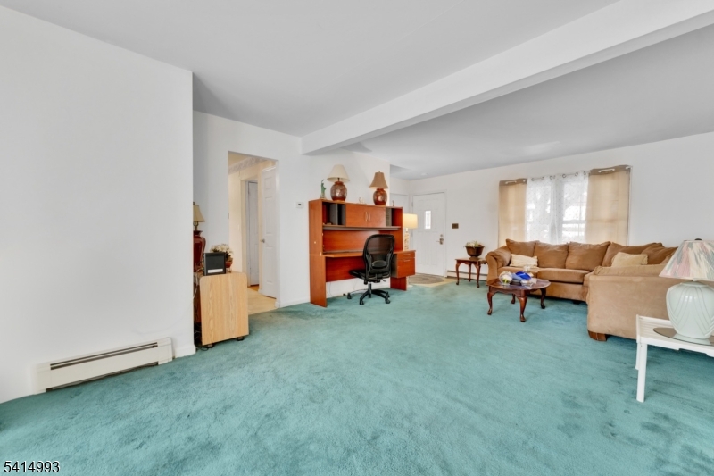 627 East Vail Road Landing, NJ 07850 - Photo 8 of 26 a living room with furniture and a baby