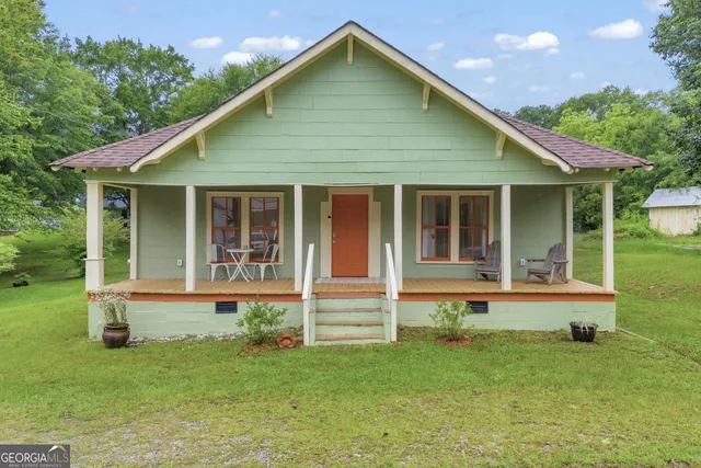 a front view of house with yard and green space