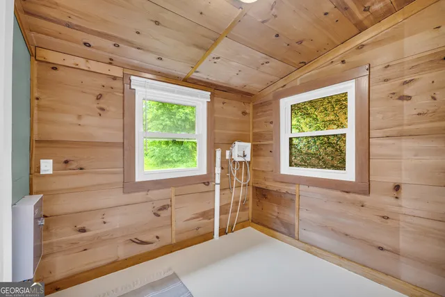 a spacious bathroom with a granite countertop tub a sink and a window