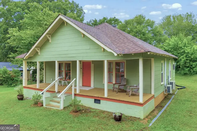 a view of a house with a yard patio and a garden