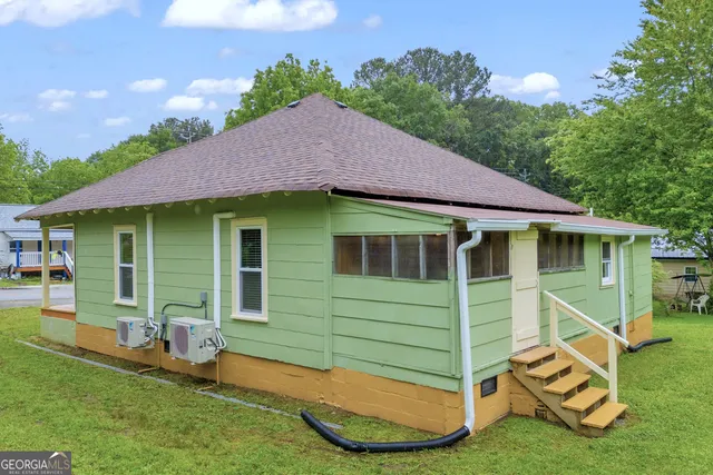 a front view of a house with a garden and yard