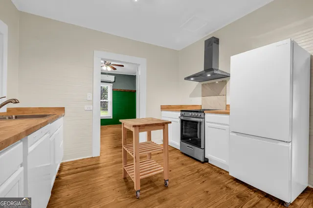 a kitchen with granite countertop a stove and a refrigerator