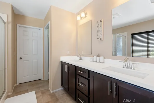a bathroom with a double vanity sink and a mirror