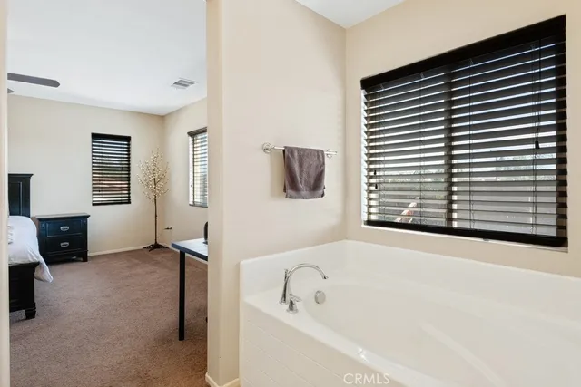 a bathroom with a bathtub and a window