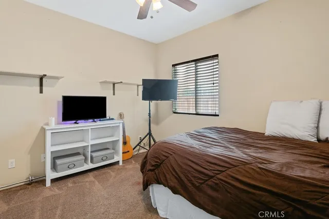 a bedroom with a bed and a flat tv screen