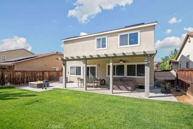 a front view of house with a yard and outdoor seating