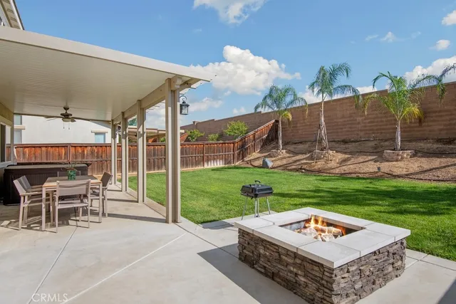 a table and chairs sitting in backyard of the house