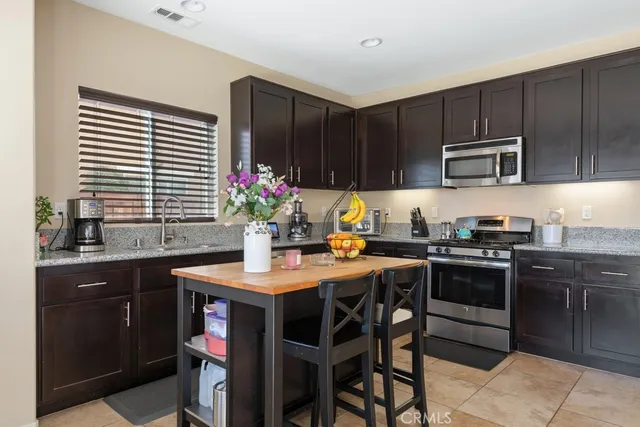 a kitchen with a stove a sink and a microwave