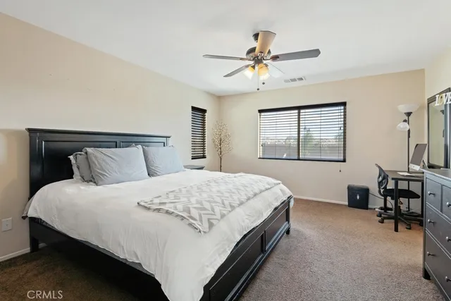a bedroom with a bed lamps and window