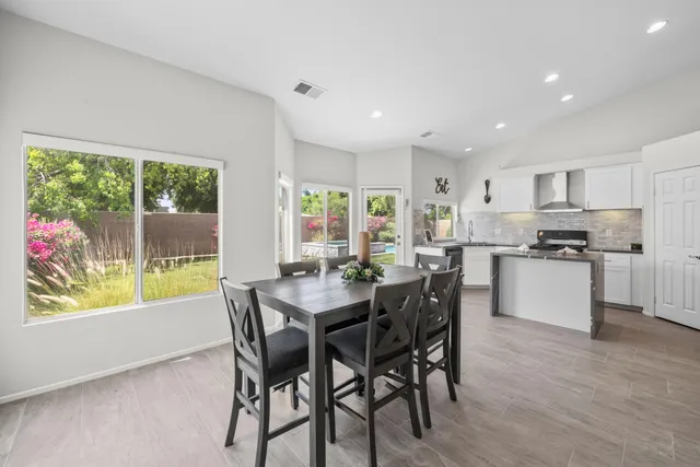 a kitchen with a table and chairs in it