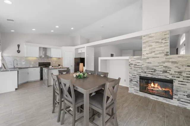 a view of a dining room with furniture and a fireplace