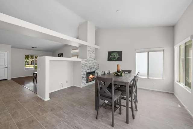a view of a dining room with furniture and chandelier