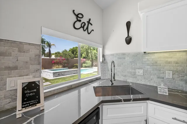 a kitchen with a sink and a large window