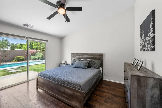 a bedroom with a bed and large window