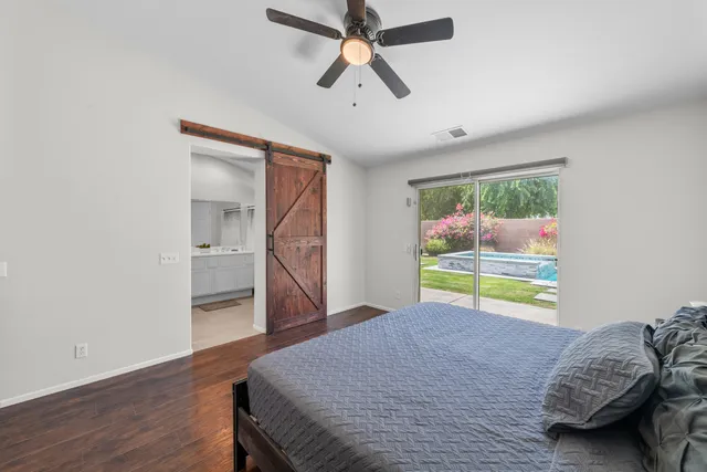 a bedroom with bed and ceiling fan
