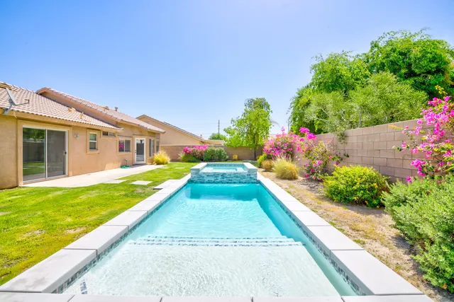 a view of house with backyard and garden