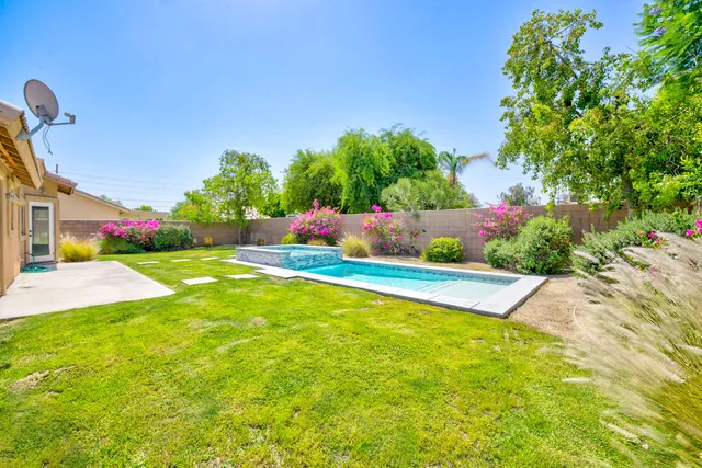 a view of a yard with swimming pool